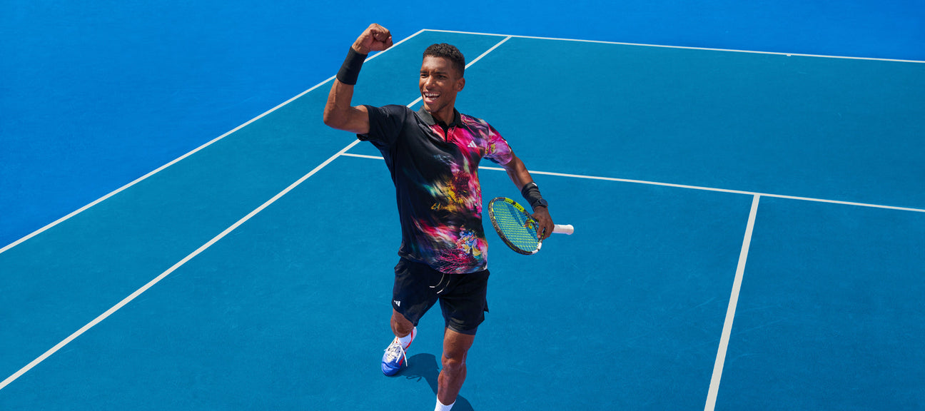 Felix Auger-Aliassime modelling the new adidas australian open 2023 clothing range on a tennis court